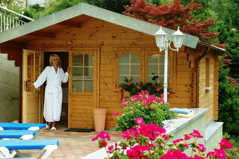 Frau in der Tür zur finnischen Sauna