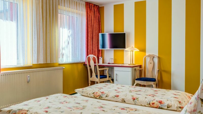 Doppelzimmer mit gestreiften Wänden