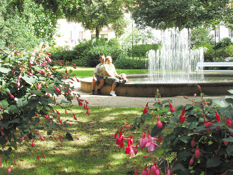 Paar an Springbrunnen im Park